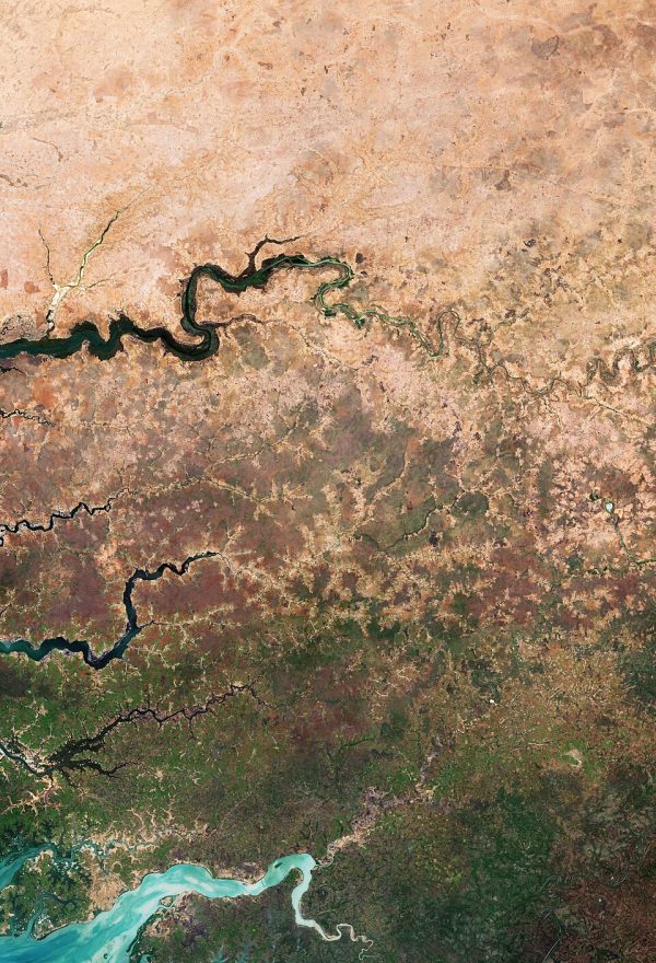 Satellitenbild zeigt Übergang von trockener Landschaft zu grüner Vegetation entlang eines Flusses in Afrika