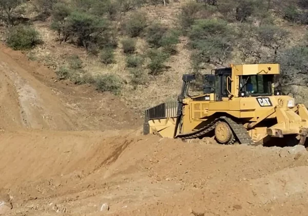 Bulldozer schiebt Damm für Regenwasserspeicherung im Khomashochland auf
